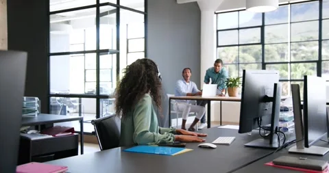 Happy diverse colleagues using computer with headset, discussing work and Stock Footage 317290389