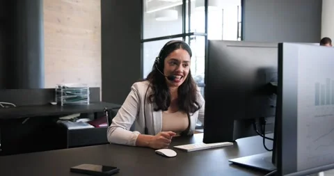 Happy diverse colleagues using computer with headset, discussing work and Stock Footage 317290420