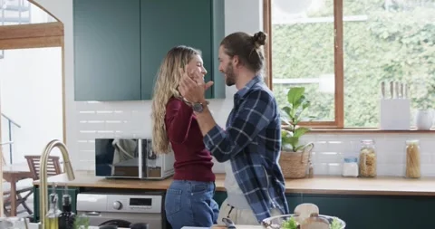 Happy diverse couple dancing in kitchen at home, in slow motion Stock Footage 341466928