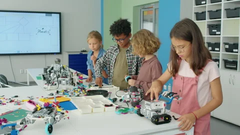 Happy Diverse Kids Constructing Robot Models at Science Camp Video stock 244176802