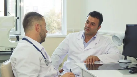 Happy doctors discuss something and laugh Stock Footage 80995989