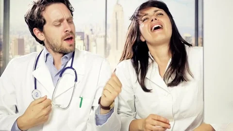 Happy doctors singing and dancing in office funny slow motioin Stock Footage 79230363