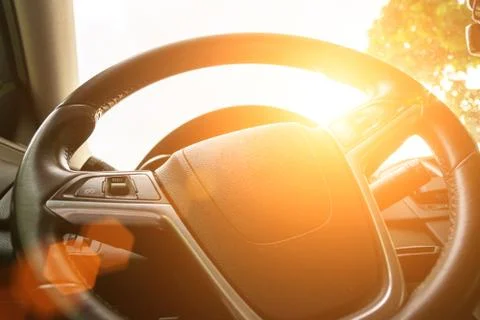 Happy driver inside car at sunset. Young man have fun ride trip travel on roa Stock Photos
