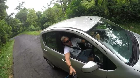 Happy Driver Man Driving in Car with GoPro On Road Trip Vidéo 66248592