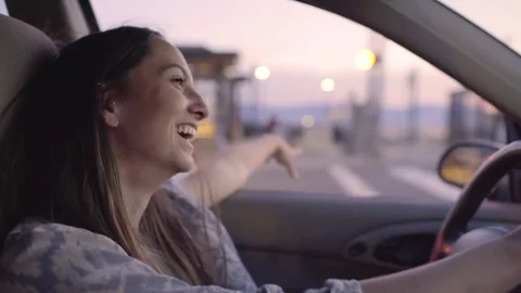 Happy Driver Puts Her Arm Out Car Window, She Laughs At Something Funny Stock-Footage 76971033