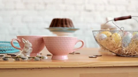 Happy Easte. Easter eggs sitting at a festive table with basket and Bunny Video stock 171973449