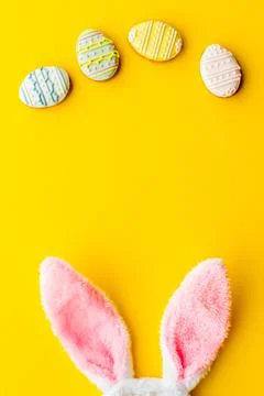 Happy Easter background. Bunny ears with eggs cookies, space for text Stock Photos