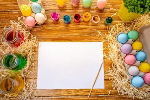 Happy Easter. Background with colorful eggs in basket. Table decorating for Stock Photos