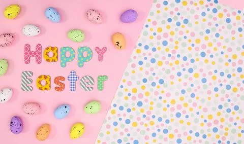 Happy Easter background with colorful eggs and text on pastel pink theme. Cre 写真素材