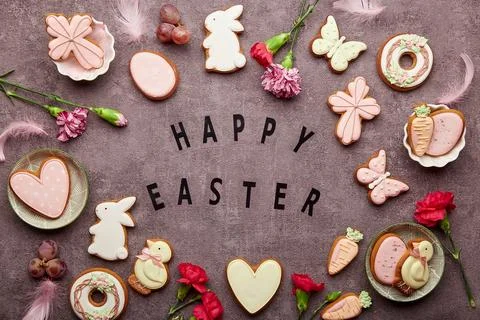 Happy Easter background. Easter aesthetic decorated cookies, aster flowers Stock Photos
