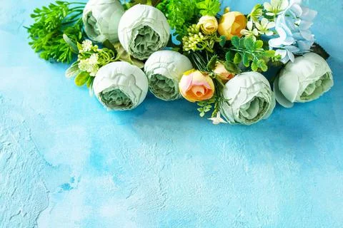 Happy Easter background. Spring flowers on a concrete blue background. Copy s Stock Photos
