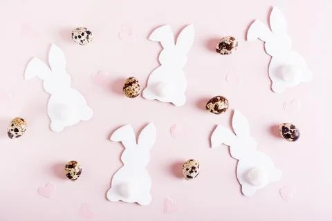Happy easter background white rabbits, quail eggs and hearts on pink top view Stock Photos