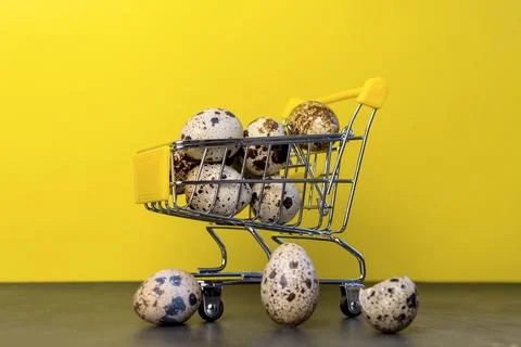 Happy Easter background.Easter eggs colorful in the shopping cart on bright y Stock Photos