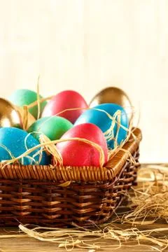 Happy Easter. Basket with Easter eggs on white background. Place for Text. Stock Photos