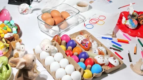 Happy easter beautiful holiday decorated table with Easter eggs, candies, paints Stock Footage 163982536