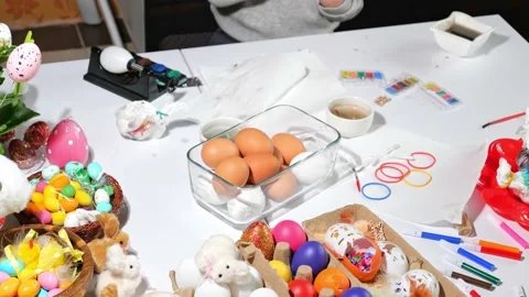 Happy easter beautiful holiday decorated table with Easter eggs, candies, paints Stock Footage 163982688