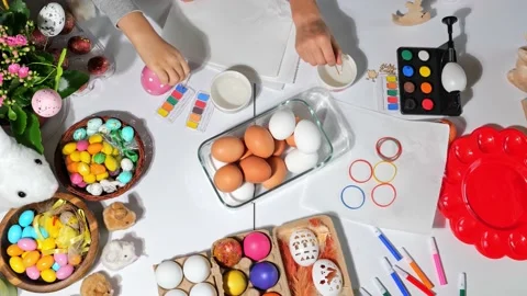Happy easter beautiful holiday table with Easter eggs, candies, paints Stock Footage 163979126