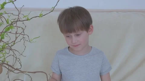 Happy Easter. Boy playing near Easter tree Stock Footage 149755846