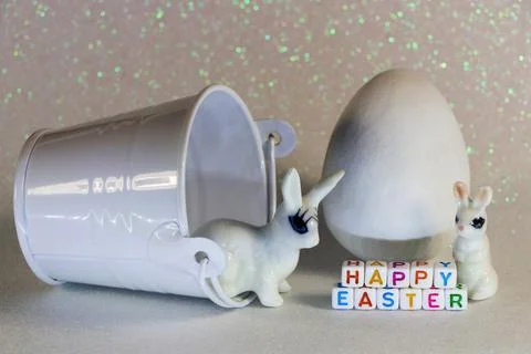 Happy Easter Bunnies With White Candy Egg And Bucket Stock Photos