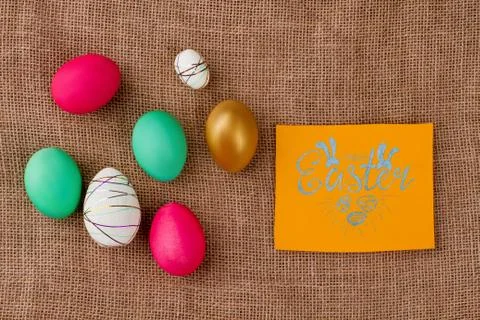 Happy Easter card on burlap background. Stock Photos