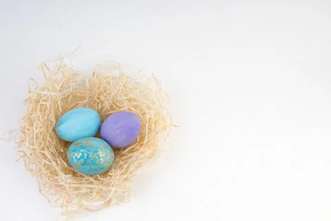 Happy Easter card. Colorful shiny eggs in a nest isolated on a white backgr.. Stock Photos