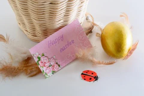 Happy easter card, gold egg, ladybug and feathers Stock Photos