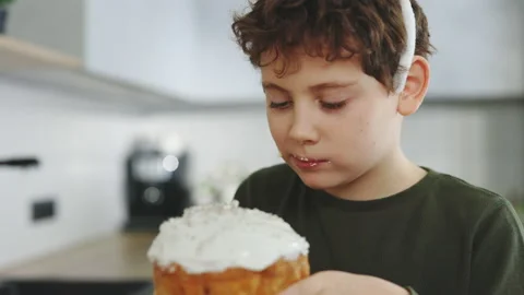 Happy easter. Caucasian funny boy wearing rabbit ears sitting in the kitchen Stock Footage 231726915