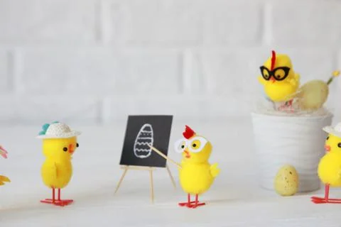 Happy Easter. Chickens conduct a master class in preparation for Easter. Stock Photos