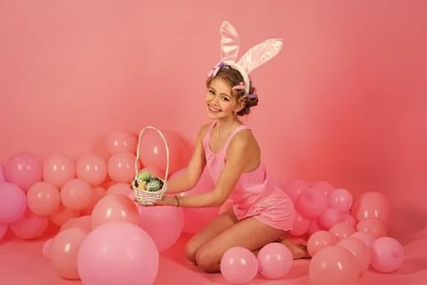 Happy easter, child in pink studio, spring. Stock Photos