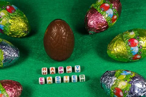 Happy Easter Chocolate Egg And Colorful Wrapped Eggs Stock Photos