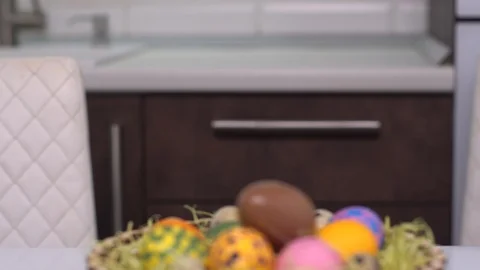 Happy easter. Chocolate egg. A little girl in rabbit ears shows up from behind Stock Footage 124857293