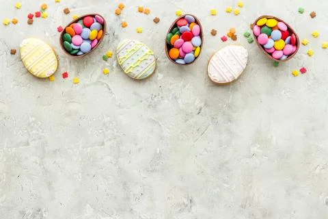 Happy Easter with chocolate eggs and sweets. Space for text Stock Photos