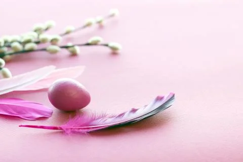 Happy Easter, colored egg, bright feathers on a purple background Stock Photos