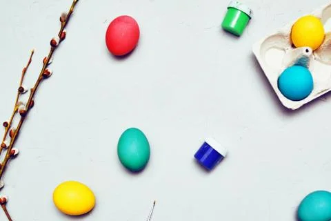 Happy easter. Colored eggs on gray concrete. Flowering, fur seal willow, on a Stock Photos