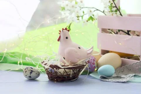 Happy Easter, colored eggs, toy chicken, twigs of blossoming cherry Stock Photos