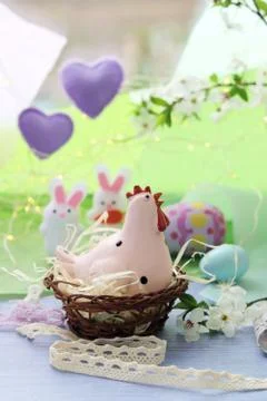 Happy Easter, colored eggs, toy chicken, twigs of blossoming cherry Stock Photos