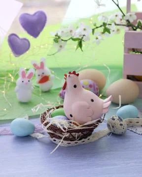 Happy Easter, colored eggs, toy chicken, twigs of blossoming cherry Stock Photos