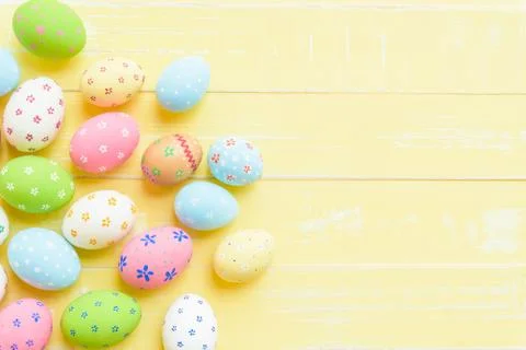 Happy easter! Colorful of Easter eggs on pastel color bright yellow and white Stock Photos