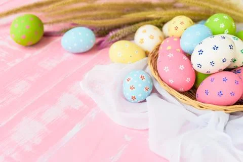 Happy easter! Colorful of Easter eggs in nest with paper star, flower and Fea Stock Photos