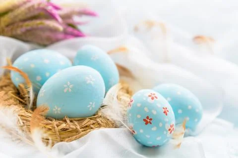 Happy easter! Colorful of Easter eggs in nest with flower,  paper star and Fe Stock Photos