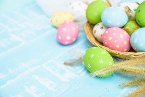 Happy easter! Colorful of Easter eggs in nest with paper star, flower and Fea Stock Photos