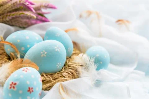 Happy easter! Colorful of Easter eggs in nest with flower,  paper star and Fe Stock Photos