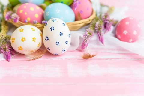 Happy easter! Colorful of Easter eggs in nest with paper star, flower and Fea Stock Photos