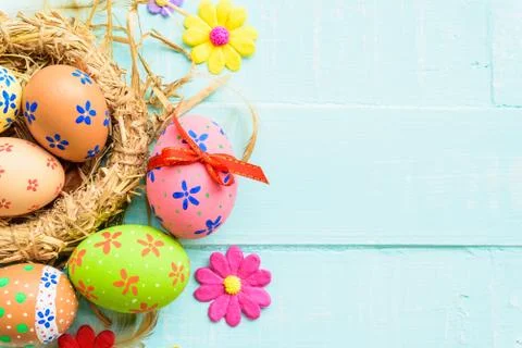 Happy easter! Colorful of Easter eggs in nest on pastel color br Stock Photos