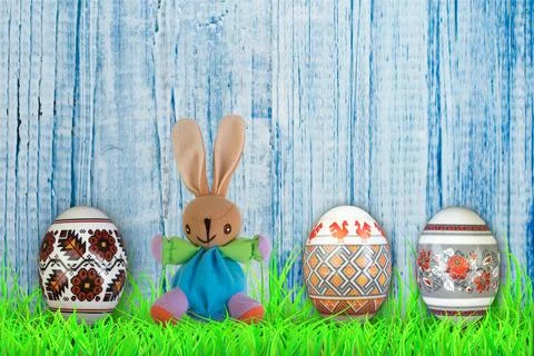 Happy Easter. Colorful easter eggs and rabbit on green grass. Stock Photos