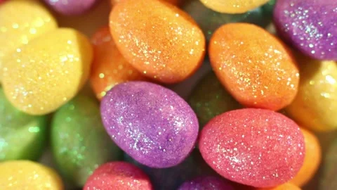 Happy Easter. Colorful glitter easter eggs spin on yellow background.Close up Stock Footage 234085581