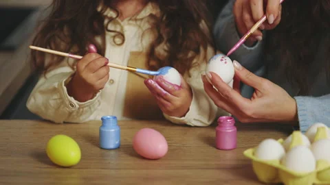 Happy easter. Coloring eggs close-up. Mom and daughter preparing for Easter Stock Footage 230155457
