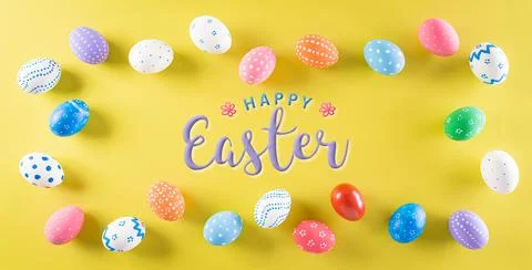 Happy easter! Colourful of Easter eggs on pastel yellow background. Top view  Stock Photos