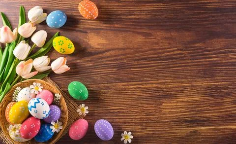 Happy easter! Colourful of Easter eggs in the nest with flower on dark wooden Stock Photos