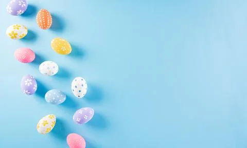 Happy easter! Colourful of Easter eggs on pastel blue background. Greetings a Stock Photos